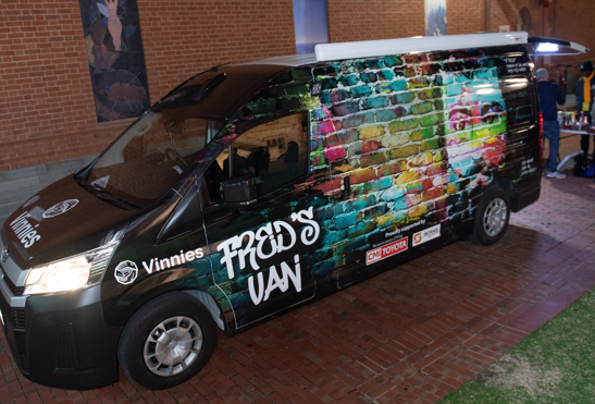A picture of Fred's van, a Vinnie's food van with graffiti paint and Fred's Van written on it.